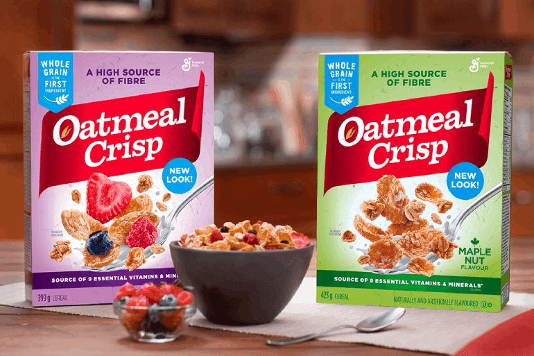 2 boxes of oatmeal crisp on a kitchen table next to bowls of oatmeal crisp and fruit