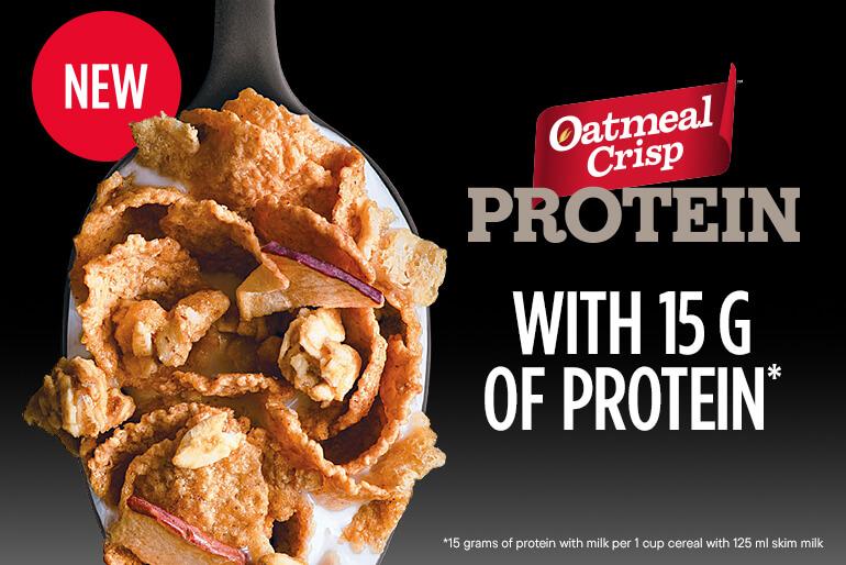A spoonful of Oatmeal Crisp cereal with visible flakes and nuts. Text reads 'New Oatmeal Crisp Protein with 15 G of Protein.' Asterisk note indicates 15 grams of protein with milk per 1 cup cereal with 125 ml skim milk.